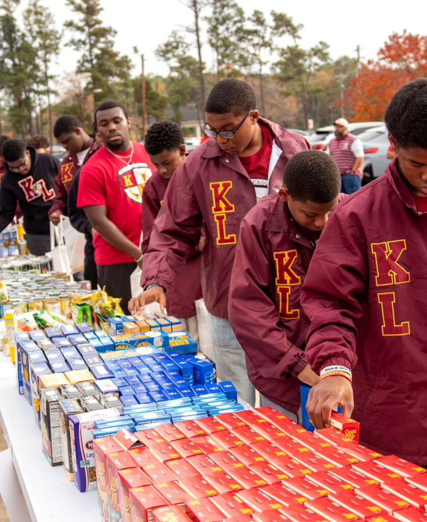 Kappa League participants sorting and packing goods at a Columbia (SC) Alumni Chapter community service drive